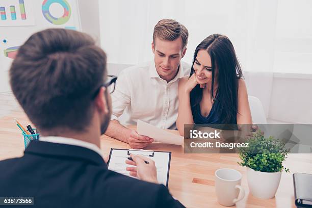 Real Estate Agent Helping Young Family To Buy Flat Stock Photo - Download Image Now - Financial Advisor, Family, Advice