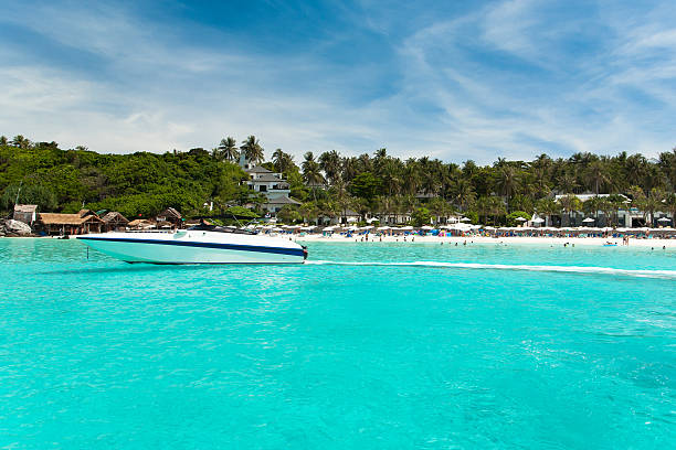 istock Yacht under the blue sky against a tropical beach 636177836