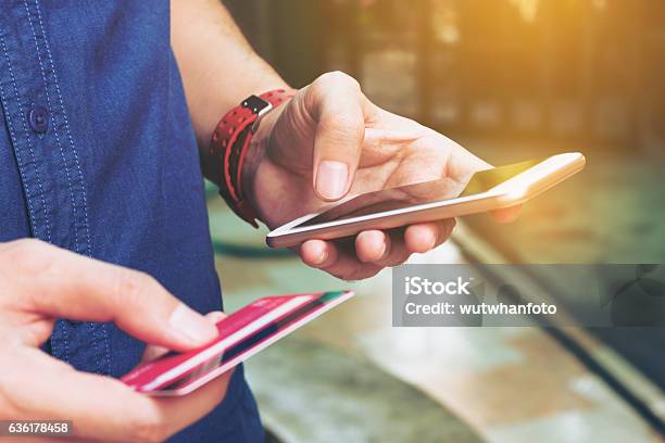 Man Use Smart Phone And Holding Credit Card With Shopping Stock Photo - Download Image Now