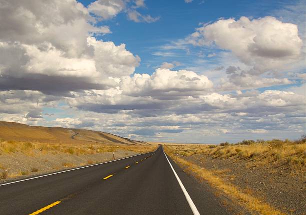 istock Beautiful Clouds Over A Long Road In Eastern Washington 636180074
