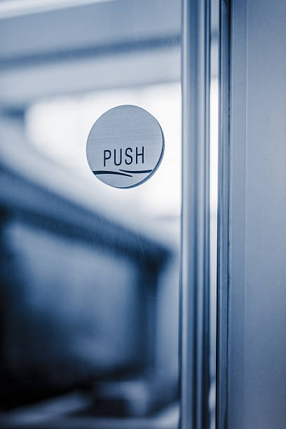 istock glass door with chrome handle and push sign on door 636180962