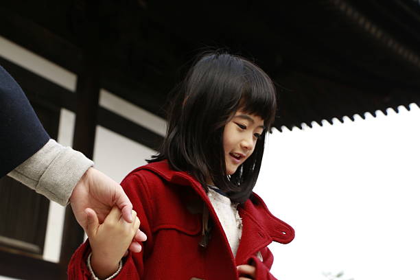 Asian woman standing under Chinese New Year couplets