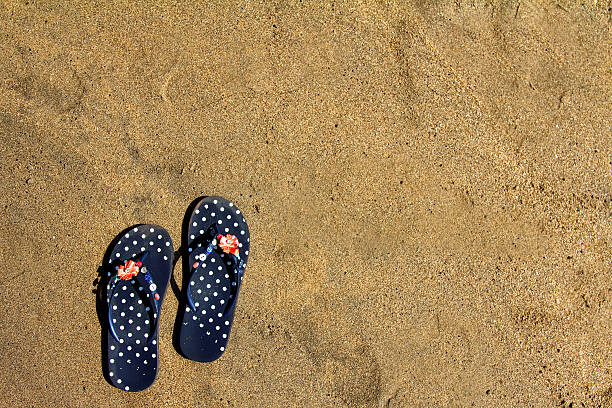 istock Flip flops on sand at Anjuna beach in Goa (India) 636184976