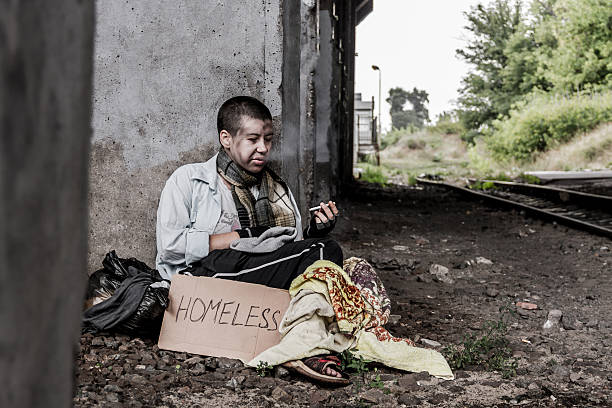 istock Homeless woman smoking 636186276
