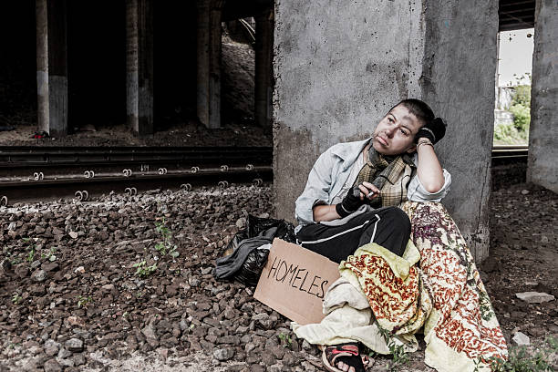 istock Homeless woman smoking 636186472