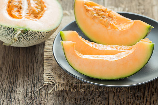 istock Fresh sweet melon on the old wooden table 636188070