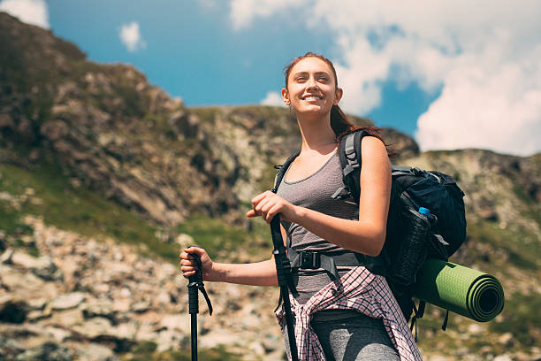 Happy female hiker looking at the view of the mountain.