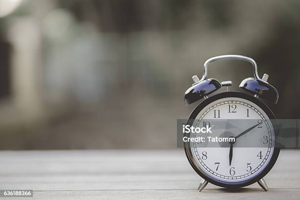 Retro Alarm Clock On Wooden Table Vintage Style Stock Photo - Download Image Now - Change, Clock, Sleeping