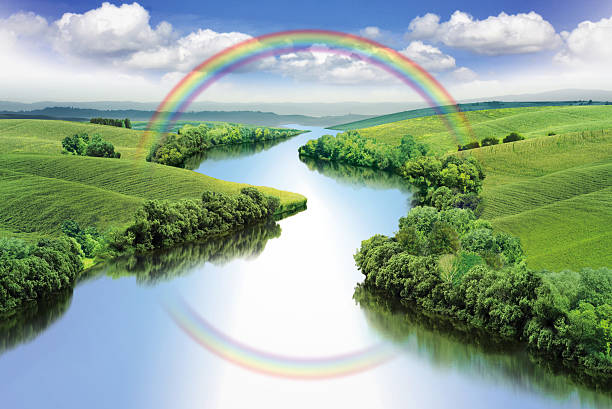 Rainbow over river stock photo