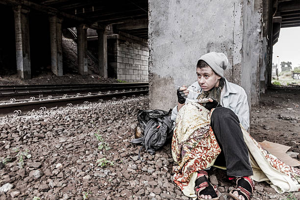 istock Homeless woman having meal 636188800