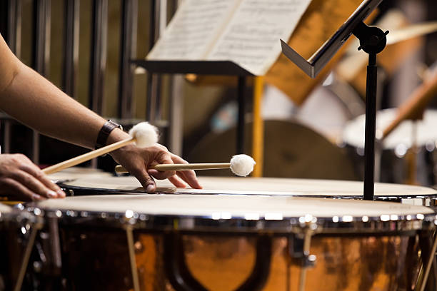 Hands musician playing the timpani  Hands musician playing the timpani in the orchestra closeup percussion instrument stock pictures, royalty-free photos & images