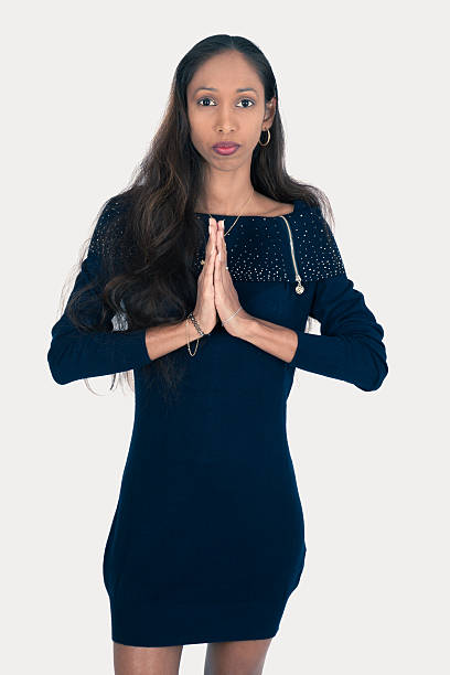 istock Beautiful woman doing different expressions in different sets of clothes: prayer 636192216