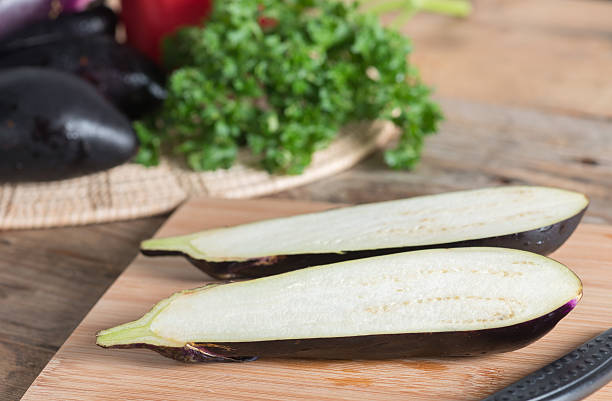 istock Half of eggplant on wood cutting board. 636194664