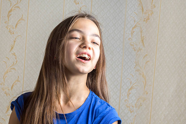istock girl singing with her mouth open 636195024