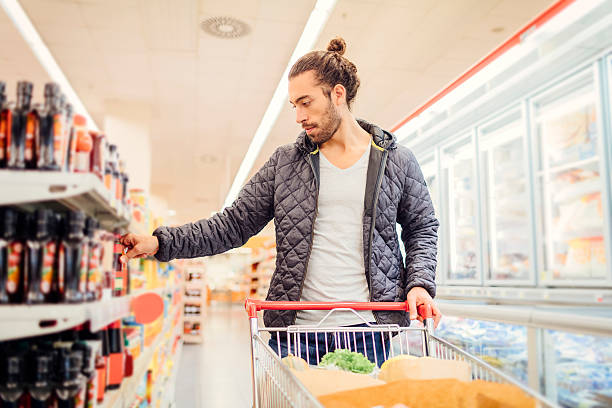 istock Young Bearded Man In A Supermarket. 636195326