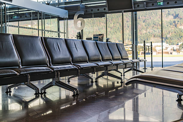 istock Row of empty seats at an airport terminal 636195436