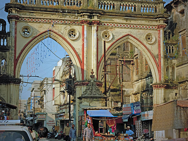 Ancient Gujarati gateway, India Junagadh, India - November 3, 2016: The large old double gateway, or Chord Darwaja, in the ancient city of Junagadh in Gujarat The ancient leads to the main market place and trading area and allows access to pedestrians and motorized traffic junagadh stock pictures, royalty-free photos & images