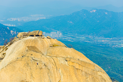 View of Seoul valley behind Insubong peak in Bukhansan mountain in South Korea. Horizontal