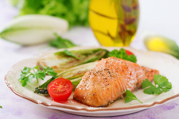 istock Baked salmon with Italian herbs and garnished with chicory 636197406