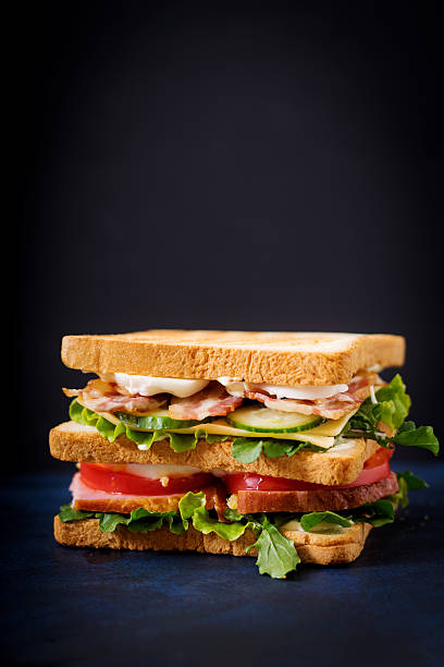istock Big Club sandwich with ham, bacon, tomato, cucumber, cheese, eggs 636198712