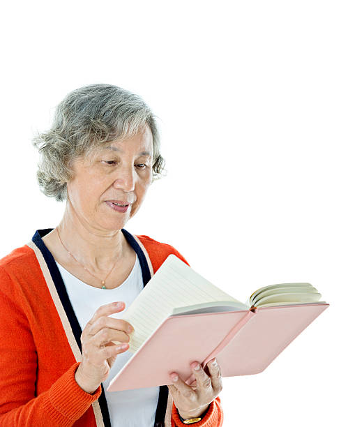 istock Asian senior woman reading a book 636198748
