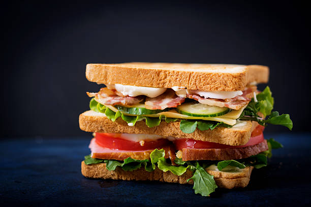 istock Big Club sandwich with ham, bacon, tomato, cucumber, cheese, eggs 636198786