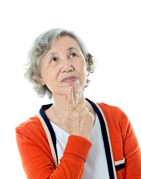 istock Senior woman putting finger on lips 636198850