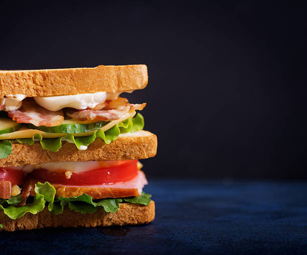 istock Big Club sandwich with ham, bacon, tomato, cucumber, cheese, eggs 636198856