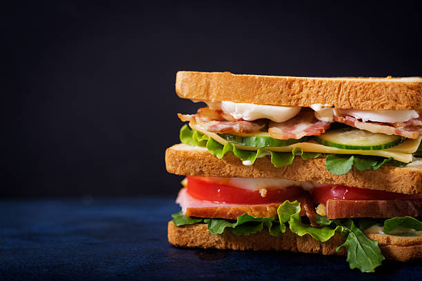 istock Big Club sandwich with ham, bacon, tomato, cucumber, cheese, eggs 636198930