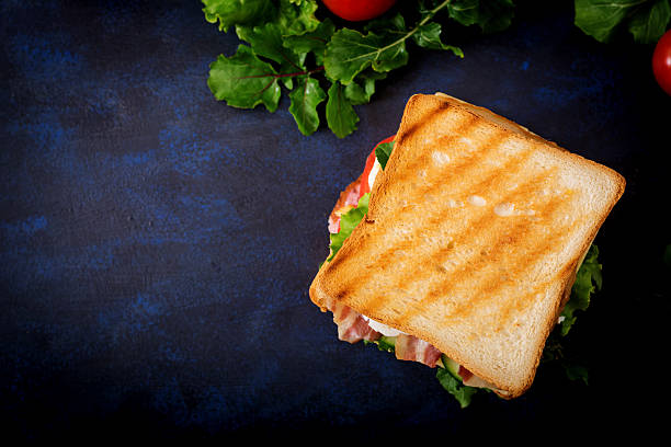 Big Club sandwich with ham, bacon, tomato, cucumber, cheese, eggs stock photo