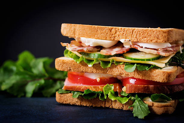 istock Big Club sandwich with ham, bacon, tomato, cucumber, cheese, eggs 636199222
