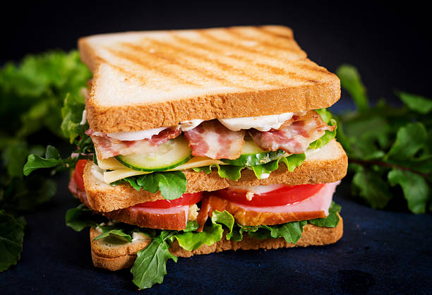 istock Big Club sandwich with ham, bacon, tomato, cucumber, cheese, eggs 636199296