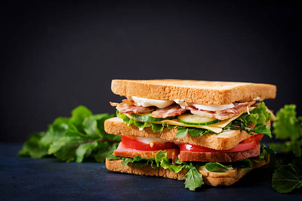 istock Big Club sandwich with ham, bacon, tomato, cucumber, cheese, eggs 636199342