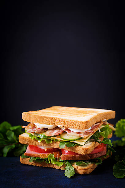 istock Big Club sandwich with ham, bacon, tomato, cucumber, cheese, eggs 636199398