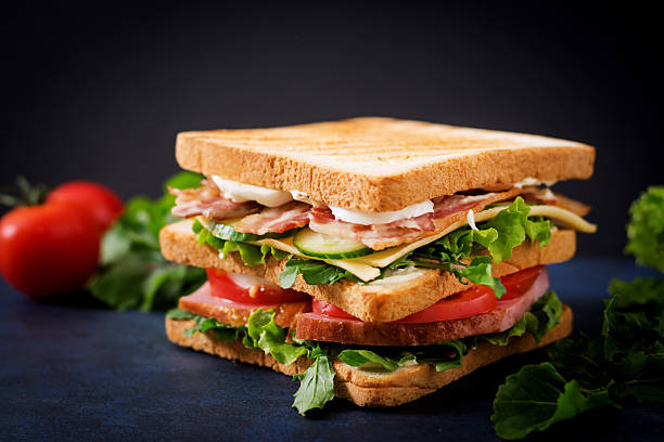 istock Big Club sandwich with ham, bacon, tomato, cucumber, cheese, eggs 636199468