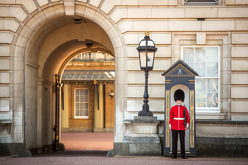 London, United Kingdom - September 11, 2016: A Sentry of the Grenadier Guards stands outside Buckingham Palace.