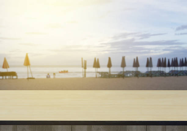 istock Wood table top on sea and beach background 636201762
