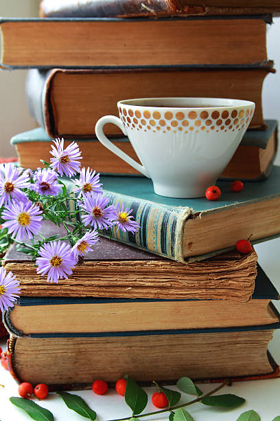 istock stack of old books and cup with flowers and rowan 636203772