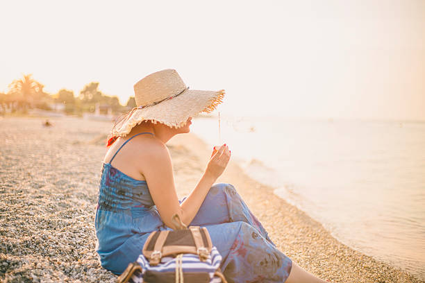 istock beautiful young female enjoying a day at the beach 636204026