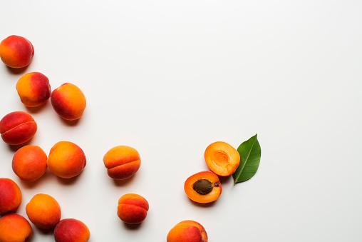 Fresh cut apricot fruits on white background
