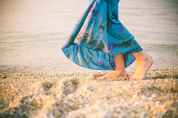 istock woman's beautiful legs on a beach 636204816