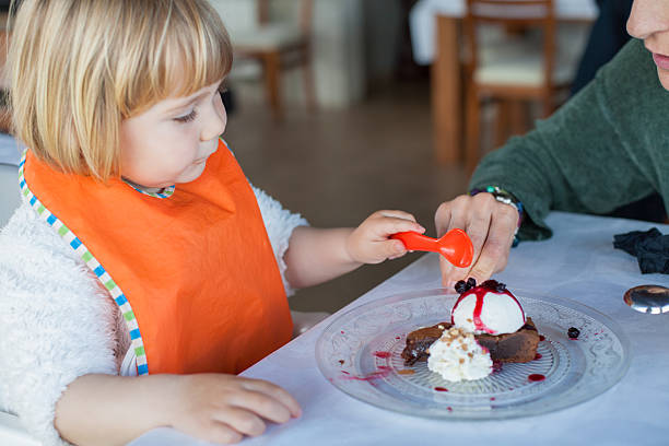 istock child and mother sharing chocolate cake 636205308