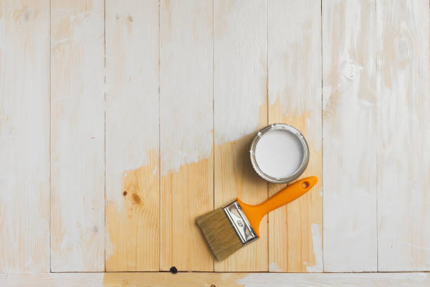 istock Copyspace with paintbrush and can lying on partially painted wooden 636205352