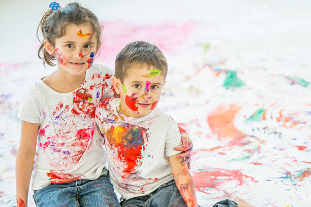 istock Siblings Painting Together 636205410