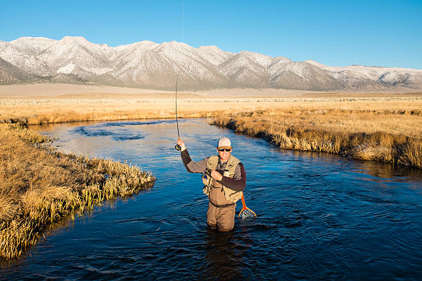 istock Fly Fisherman On The River Casting 636206652