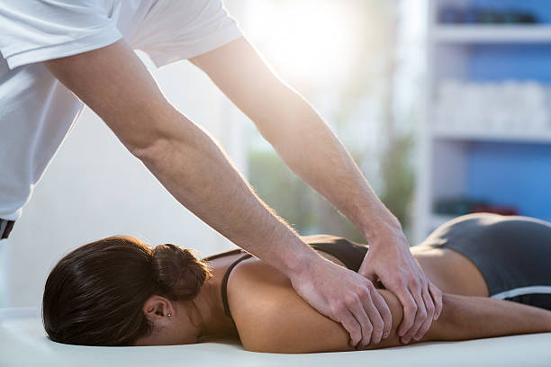istock Woman receiving arm massage from physiotherapist 636208148