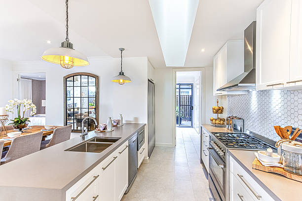 istock Luxury kitchen with hanging lamps over the counter and dinner 636208246
