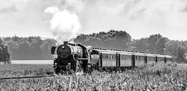 Photo of Steam locomotive with passenger railway cars