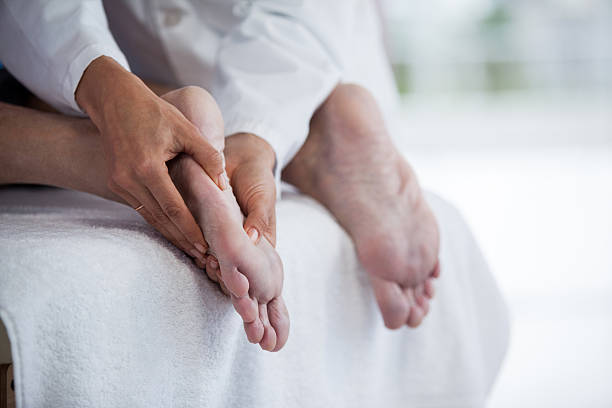 istock Senior man receiving foot massage from physiotherapist 636209370