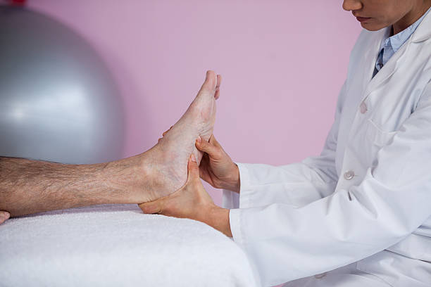 istock Senior man receiving foot massage from physiotherapist 636209424